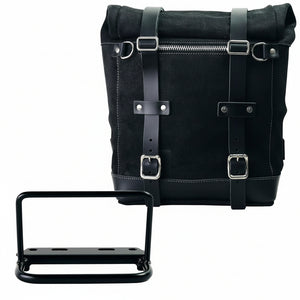 Black roll-top bicycle pannier bag with leather straps, silver buckles, and a front zipper, shown with a black mounting bracket on a white background. The brand name 'UNIT GARAGE' is printed on the top right corner of the bag.